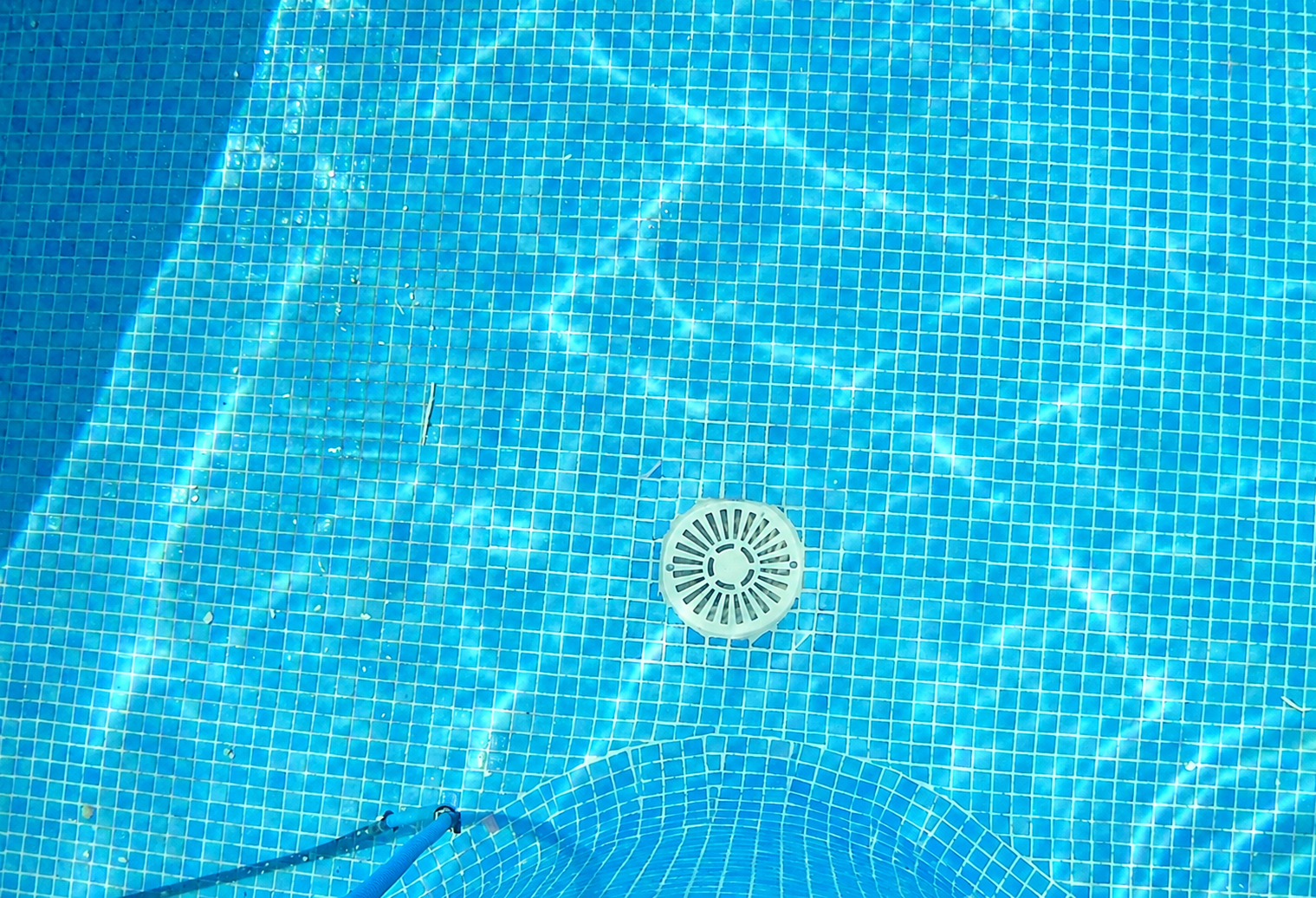 Completed MCC pool drain repair with replacement mosaic tiles neatly finished underwater